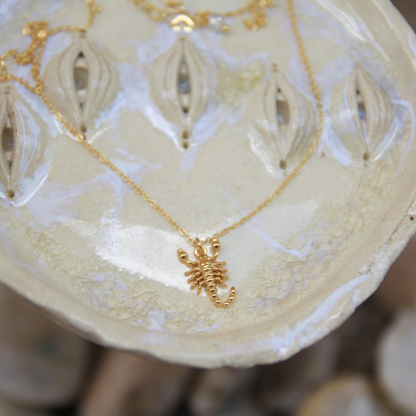 gold scorpion pendant on short gold chain